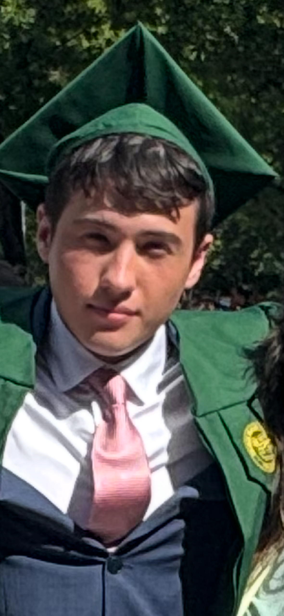 Serhii in his graduation cap and gown